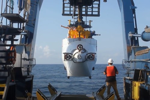 research vessel being lowered into the Galapagos marine reserve